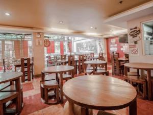 a dining room with wooden tables and chairs at Haeinsa Condotel in Manila