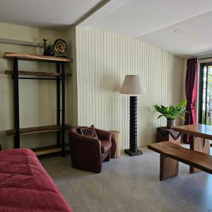 a living room with a couch chair and a table at home stay pool villa chiang mai in Ban Thung Satong