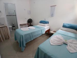 a room with two beds and a mirror at Hospedagem Famíliar in Cotia +24 photos