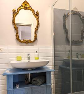 a bathroom with a sink and a mirror at La Casina dei Libri in Vetralla
