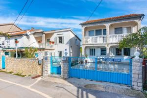 a blue gate in front of a house at Villa Gaspar in Brzac