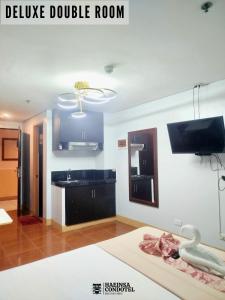 a living room with a sink and a tv at Haeinsa Condotel in Manila
