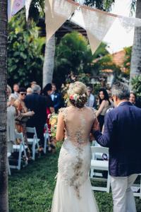 a bride and groom walking down the aisle at their wedding at Motel 98 in Rockhampton