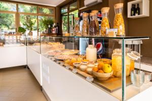 a display case with a lot of food and drinks at Club del Sole Viareggio Family Collection in Torre del Lago Puccini