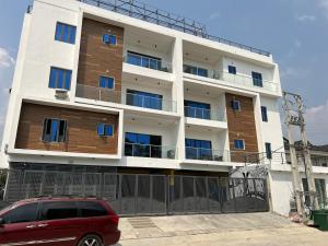 a building with a red van parked in front of it at Luxury 1 BR With Swimming Pool & 24 Hours Security In Lekki 1 in Lagos