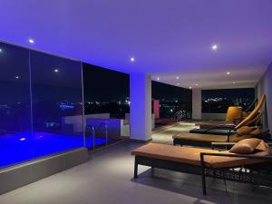a living room with a view of the city at night at Luxury 1 BR With Swimming Pool & 24 Hours Security In Lekki 1 in Lagos