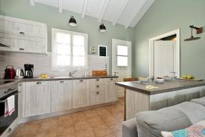a kitchen with white cabinets and a counter top at Asos Luxury Seafront Villas, Kefalonia, 100m beach & center, 4 stars services, Parking - near Myrtos - Fiskardo in Asos