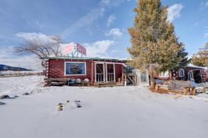 a building in the snow with skis in front of it at Winmar Cabins in Twin Lakes