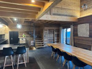 a large dining room with a large wooden table and chairs at Chalet Mélèzes in Les Angles