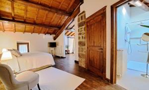 a bedroom with a bed and a desk and a chair at L'Archetto Dimora Storica in Viterbo