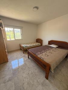 a bedroom with a large bed and a bench at Casa en Tanti con pileta in Tanti