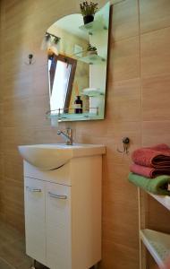 a bathroom with a sink and a mirror at The Village Cottage in Natsovtsi +57 photos