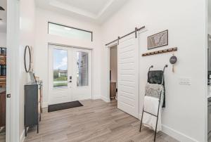un corridoio bianco con porta e specchio di Beautiful, fun home w/3 masters, pool & spa a Cape Coral Altre 61 foto