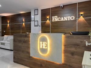 a lobby with a reception desk with a sign that reads work enigma at Hotel Encanto in Popayan +97 photos