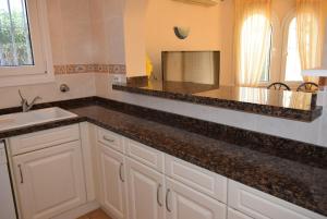 a kitchen with a counter top and a sink at Anacasa Picasso Oliva Nova CH1400 in Oliva +23 photos