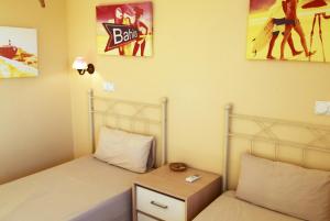 a small bedroom with a bed and a night stand at Anacasa Picasso Oliva Nova CH1400 in Oliva