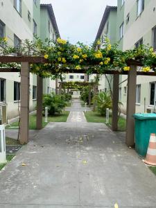an archway with yellow flowers on it in a building at Cantinho da day in Aracaju