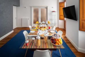 a dining room with a table with food on it at Marcus Suite in Cagliari