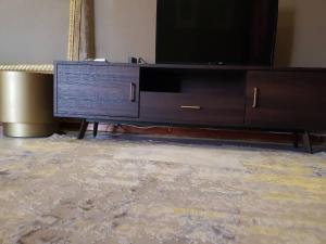 a living room with a tv on a dresser at 3-Beds Nalaksuites - Selfcatering apartments in Gaborone