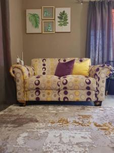 a living room with a polka dot couch at 3-Beds Nalaksuites - Selfcatering apartments in Gaborone +2 photos