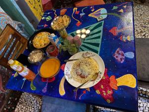 a blue table with a plate of food on it at Bob hostel in Jodhpur +30 photos