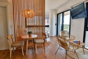 a dining room with a table and chairs at Modern & Bright Studio in Asuncion