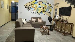a living room with two couches and a tv at Pousada Biribiri in Salvador