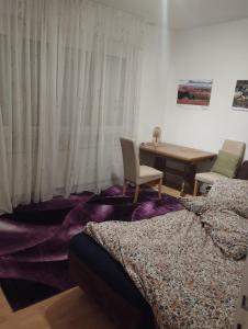 a bedroom with two beds and a desk and a table at Big room for 2 pers, 9 min to trade fare, FREE parking in Frankfurt/Main