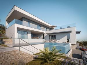 a house with a swimming pool in front of it at Moderna villa "Split na dlanu" s grijanim bazenom in Klis