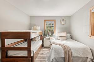 a bedroom with two bunk beds and a window at Belleayre Mountain House in Arkville