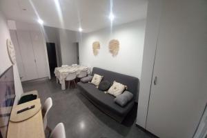 a living room with a couch and a dining table at Sol y playa duplex in Vinarós