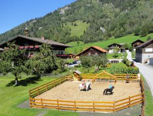 a group of people in a corral with animals in it at Moarbauer in Dorfgastein
