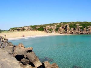 a beach with a group of people on the beach at 1st floor apartment in the city - air conditioned - wifi in Avola