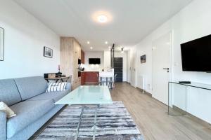 Μια τηλεόραση ή/και κέντρο ψυχαγωγίας στο Appartement les pieds dans l'eau - T2 de standing