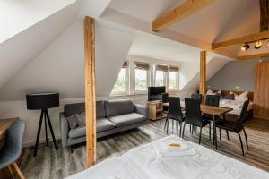 a living room with a couch and a table at ElbApartments - Sächsische Schweiz - Ferienwohnungen zum Malerweg - Bastei Urlaub in Pirna