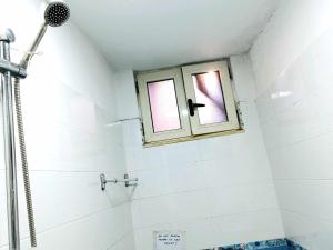 a bathroom with a shower and a window at Stairway to heaven in Shkodër