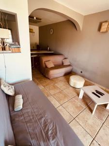 a living room with a couch and a table at Casa di Lumio, piscine privée in Lumio