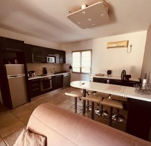 a large kitchen with a table and chairs in it at Casa di Lumio, piscine privée in Lumio