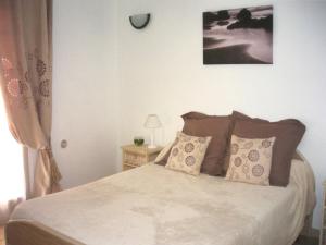 a bedroom with a bed and a clock on the wall at Casa di Lumio, piscine privée in Lumio