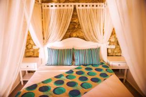 a bedroom with a bed with a canopy and curtains at Selin Hotel in Alaçatı