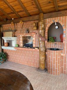 a kitchen with a brick fireplace in a house at casa Pinto Douro in Ancede