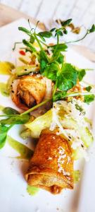 a white plate with some food on it at St Martin du canigou Chambres et Table d'hôtes de charme in Casteil