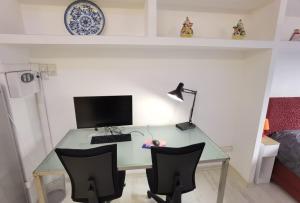 a desk with a computer and two chairs in a room at Ballarin Studio Apartment for Business Travels and Holidays in Rome
