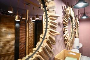 a room with a wall filled with lots of wooden sticks at Green Tiny Village Harz - Sleep Space 36 in Osterode +33 photos