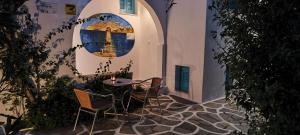 a patio with a table and chairs in a building at Ragousis Apartments in Parikia