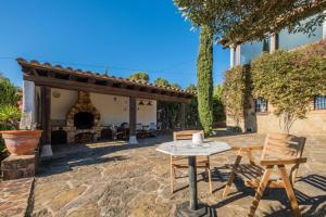 a table and two chairs on a patio at CC-1 Casa Mar y Viñas in Begur