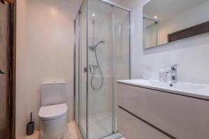 a bathroom with a shower and a toilet and a sink at CC-1 Casa Mar y Viñas in Begur +28 photos
