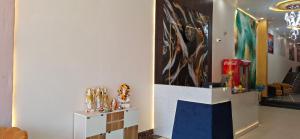 a room with a large painting on the wall at BlueNeck Ayodhya-Near ShriRam Mandir in Ayodhya