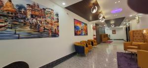 a waiting room with chairs and a painting on the wall at BlueNeck Ayodhya-Near ShriRam Mandir in Ayodhya