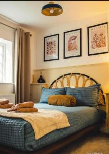 a bedroom with a bed with pillows on it at Charming, brand new townhouse near the sea in Hythe